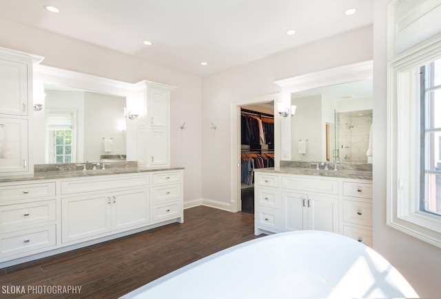 bathroom featuring hardwood / wood-style flooring, vanity, and shower with separate bathtub