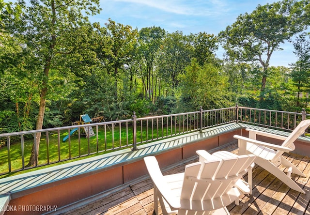 deck with a lawn and a playground