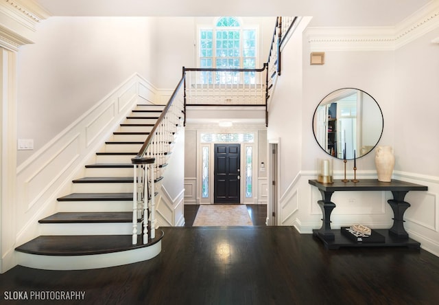 entryway featuring crown molding and dark wood-type flooring