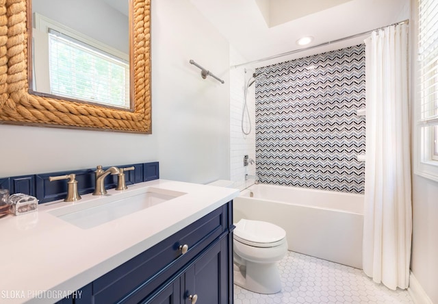 full bathroom featuring shower / bath combo with shower curtain, tile patterned flooring, vanity, and toilet