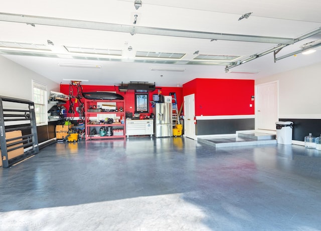 garage with stainless steel fridge