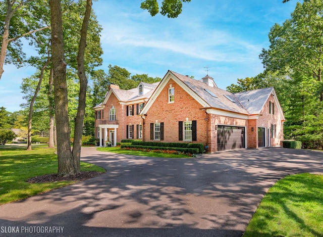 view of front of home featuring a garage and a front lawn