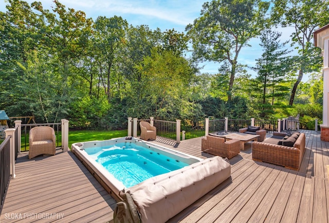 view of pool with a wooden deck and an outdoor living space