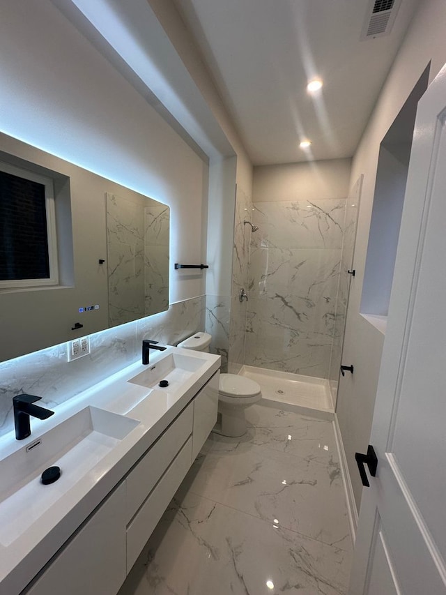 bathroom featuring vanity, toilet, and tiled shower