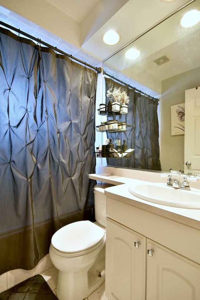 bathroom with tile patterned floors, vanity, and toilet