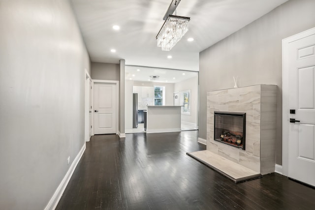 unfurnished living room with a fireplace and dark hardwood / wood-style floors