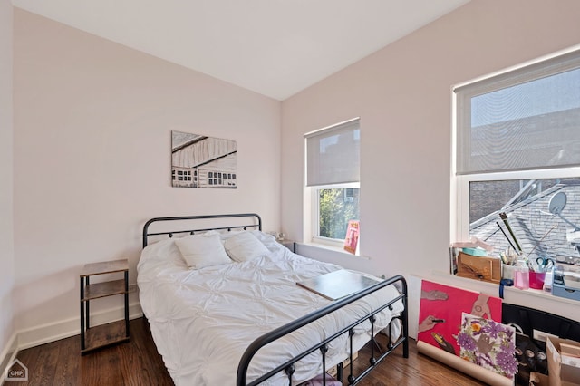 bedroom with dark wood-type flooring