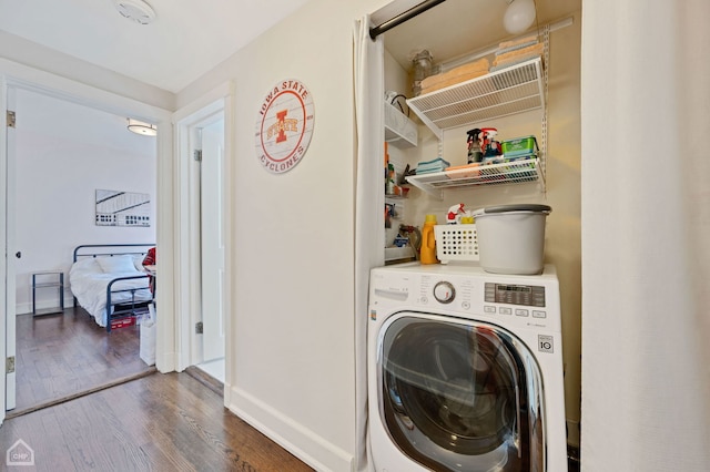 washroom featuring washer / clothes dryer and dark wood-type flooring