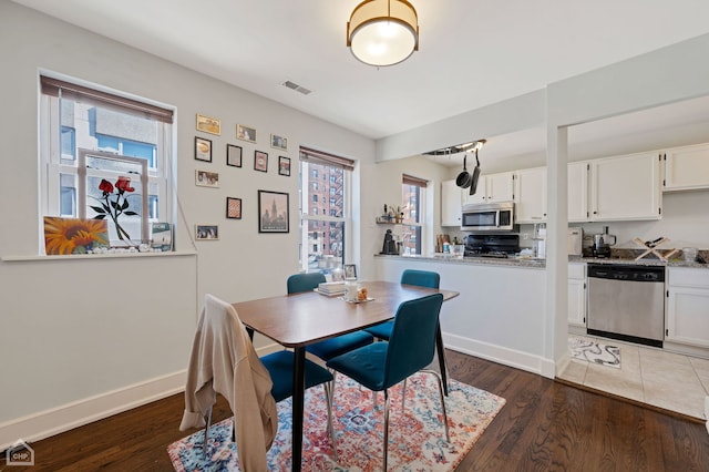 dining area with dark wood-type flooring