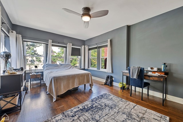 bedroom with dark hardwood / wood-style floors and ceiling fan