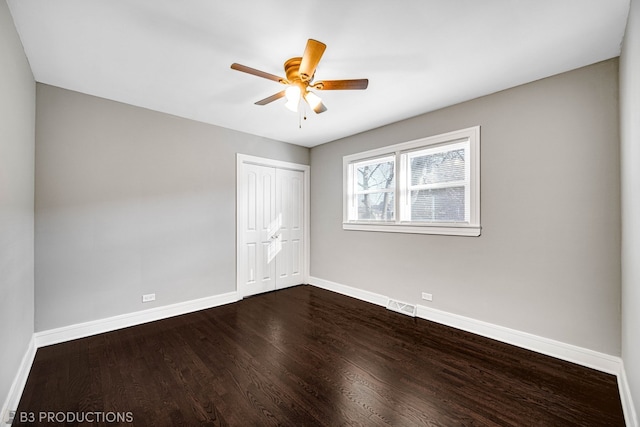 unfurnished bedroom with ceiling fan, a closet, and hardwood / wood-style flooring