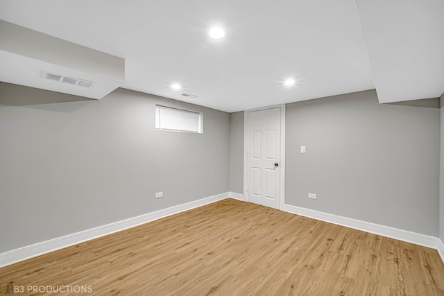 basement with light hardwood / wood-style flooring