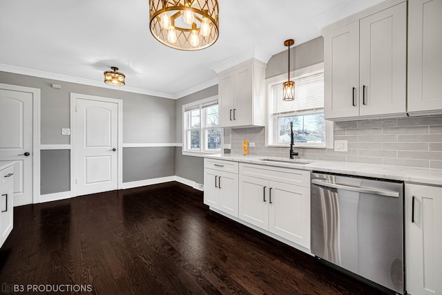 kitchen with white cabinetry, sink, stainless steel dishwasher, dark hardwood / wood-style floors, and decorative light fixtures