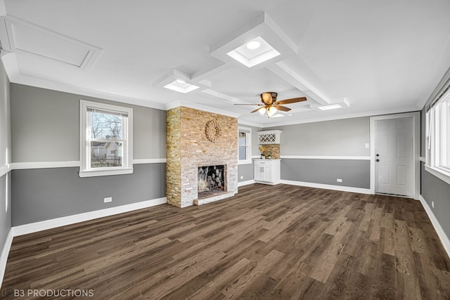 unfurnished living room with a fireplace, dark hardwood / wood-style flooring, ceiling fan, and ornamental molding