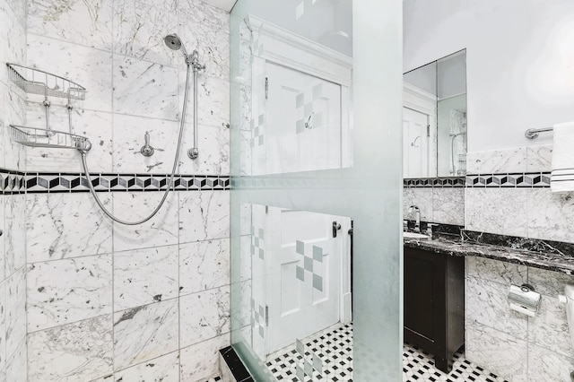 bathroom featuring vanity, tile walls, and a tile shower