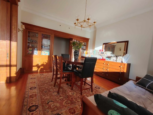 dining area featuring hardwood / wood-style floors and a chandelier