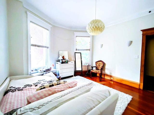 bedroom with dark wood-type flooring