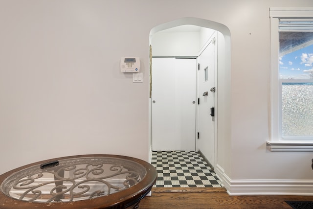 foyer entrance with dark hardwood / wood-style floors