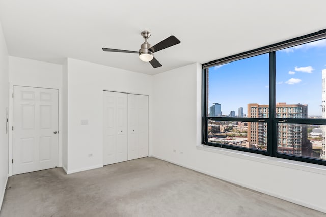 unfurnished bedroom featuring a closet, light colored carpet, and ceiling fan