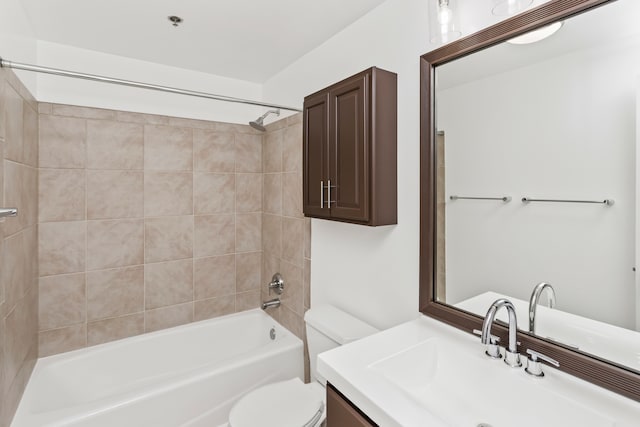 full bathroom with tiled shower / bath combo, toilet, and vanity