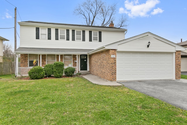 view of property featuring a garage and a front lawn