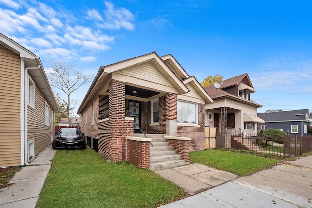 bungalow-style home featuring a front lawn