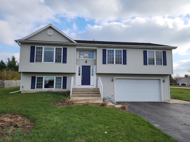 bi-level home featuring a front lawn and a garage