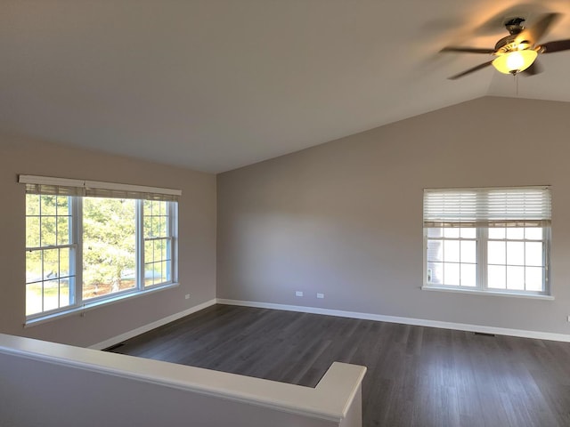 spare room with vaulted ceiling, ceiling fan, and dark wood-type flooring