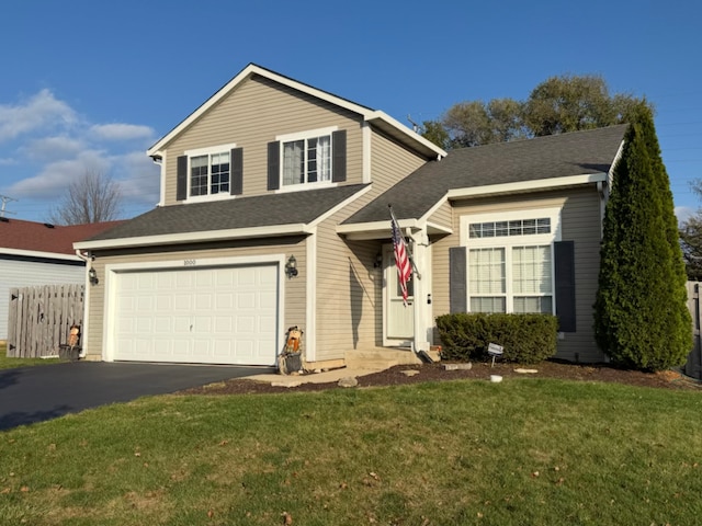 view of front property with a garage and a front lawn