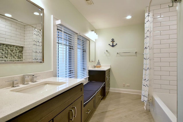 bathroom with vanity, hardwood / wood-style flooring, and shower / bath combo with shower curtain