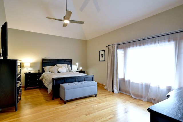 bedroom featuring ceiling fan, lofted ceiling, and light hardwood / wood-style flooring