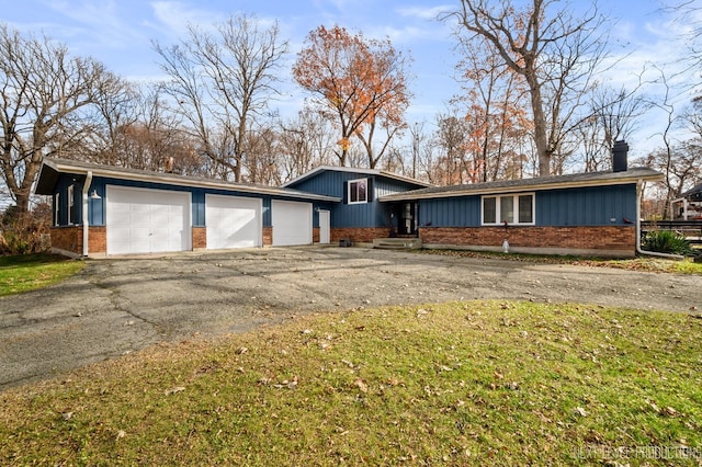 ranch-style house with a garage and a front yard