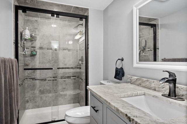 bathroom featuring vanity, toilet, and walk in shower