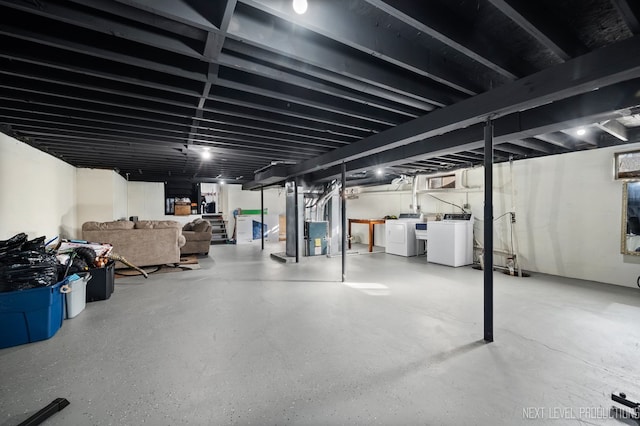 basement featuring washing machine and dryer and heating unit