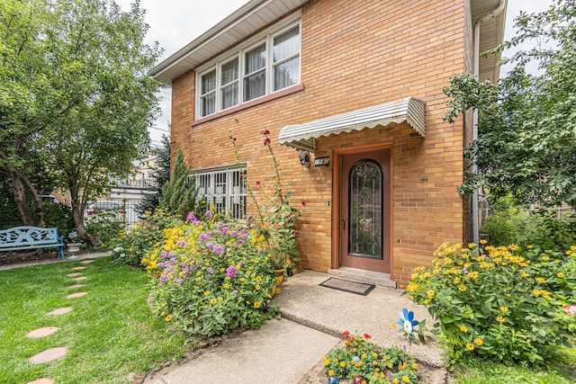 entrance to property with a lawn