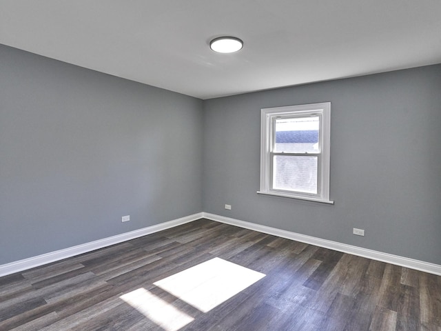 spare room featuring dark hardwood / wood-style flooring