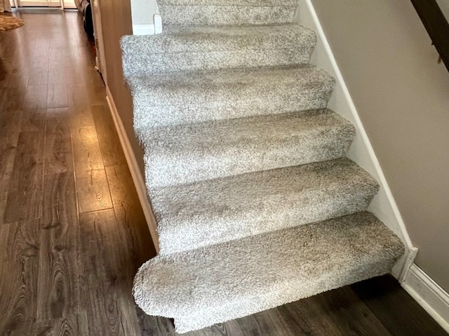 stairs with hardwood / wood-style floors