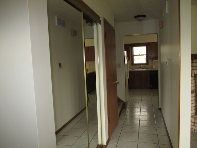 hall with sink and light tile patterned floors