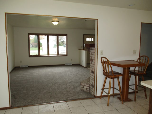 carpeted dining room featuring a fireplace