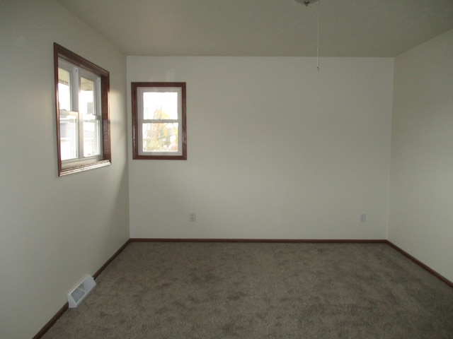 empty room featuring dark colored carpet