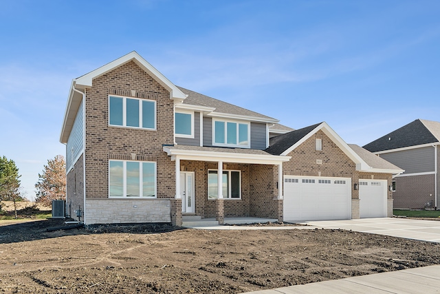 view of front of house with a garage and cooling unit