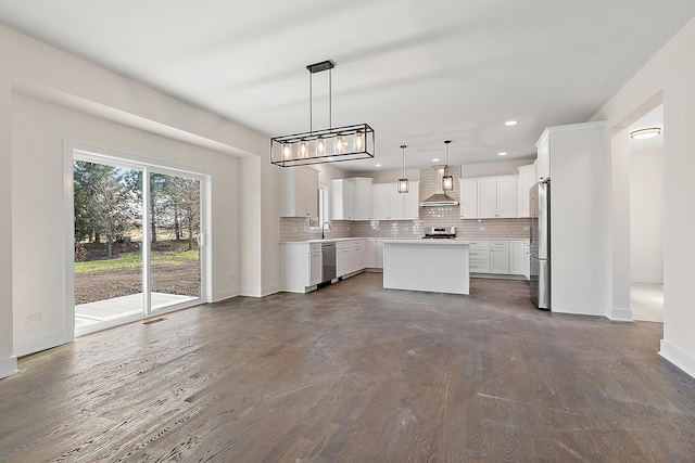 8035 Stanley Trl, Frankfort, IL 60423 - kitchen with stainless steel appliances, a center island, backsplash, baseboards, and wall chimney exhaust hood