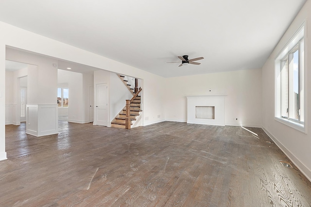8035 Stanley Trl, Frankfort, IL 60423 - unfurnished living room featuring ceiling fan, stairs, wood finished floors, and baseboards