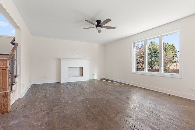 unfurnished living room with ceiling fan and dark hardwood / wood-style floors