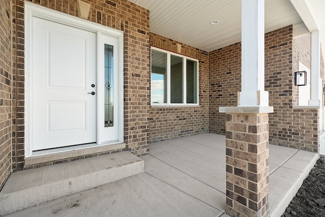 view of exterior entry with covered porch