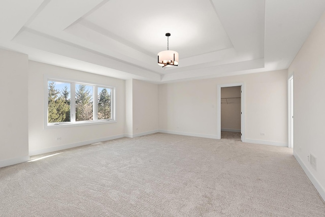 8035 Stanley Trl, Frankfort, IL 60423 - empty room with a raised ceiling, plenty of natural light, a chandelier, and light carpet