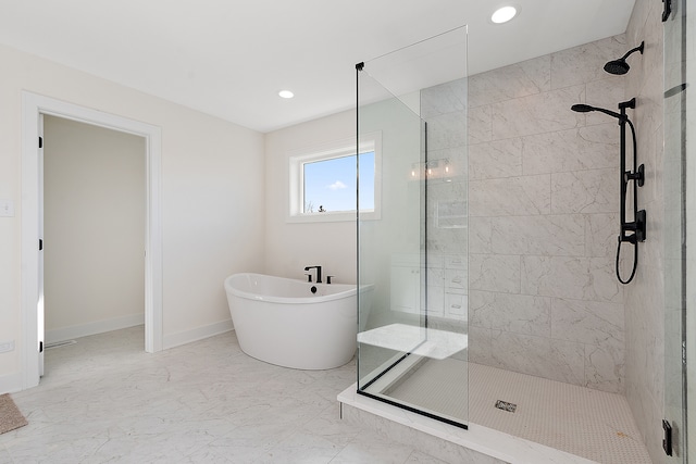 bathroom featuring shower with separate bathtub