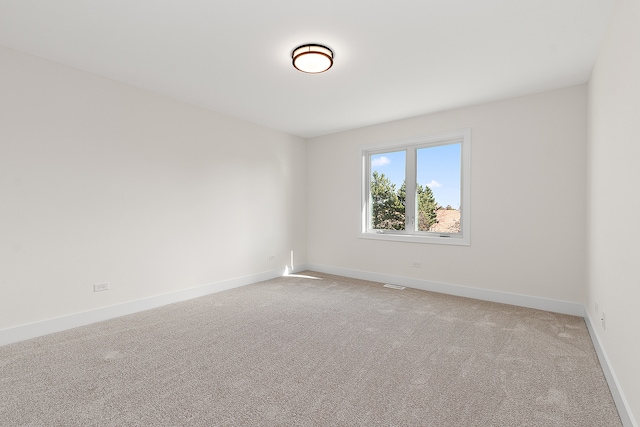 unfurnished room with light carpet