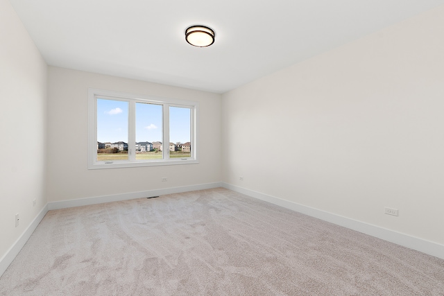 empty room featuring light colored carpet