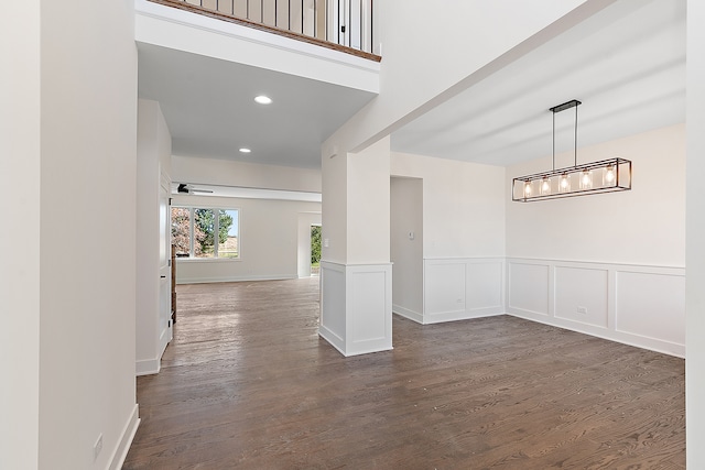 spare room featuring ceiling fan and dark wood-type flooring